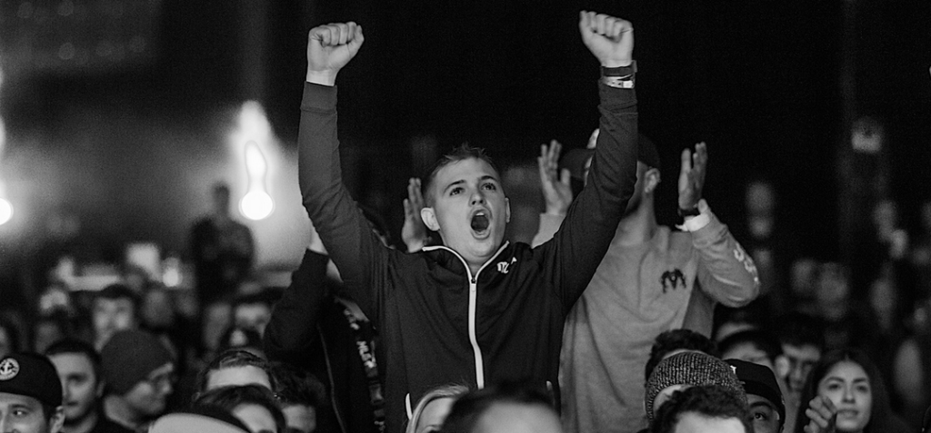 Epic black and white photo of a fan standing up and cheering at the Halo World Championship