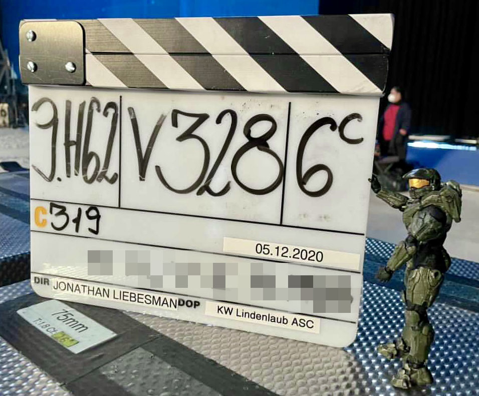 Production slate of the Halo television show held by a Master Chief action figure.