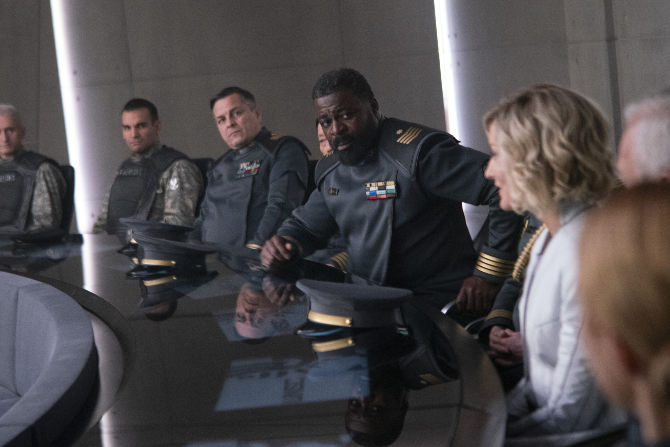 Halo TV still of Halsey, Keyes, and other UNSC personnel gathered at a round table.