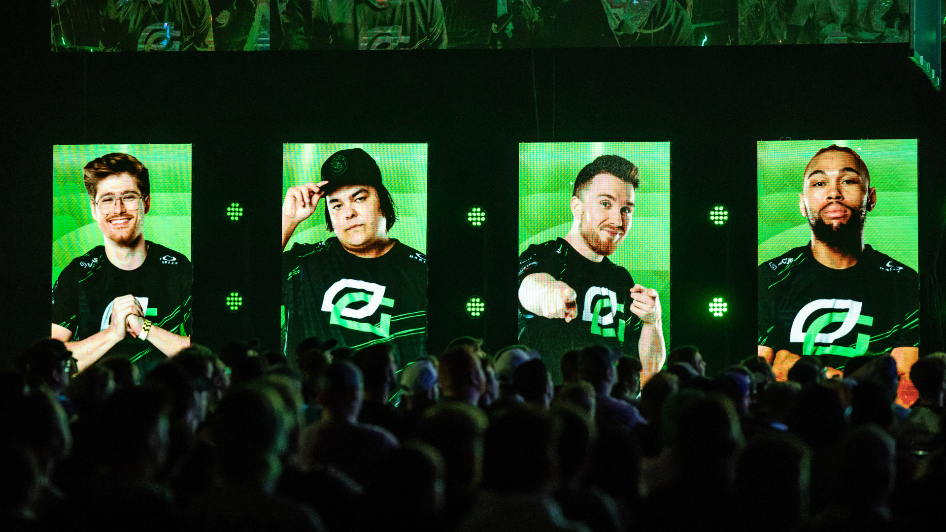 Optic Gaming players on LED screens illuminating fans in the crowd in green light