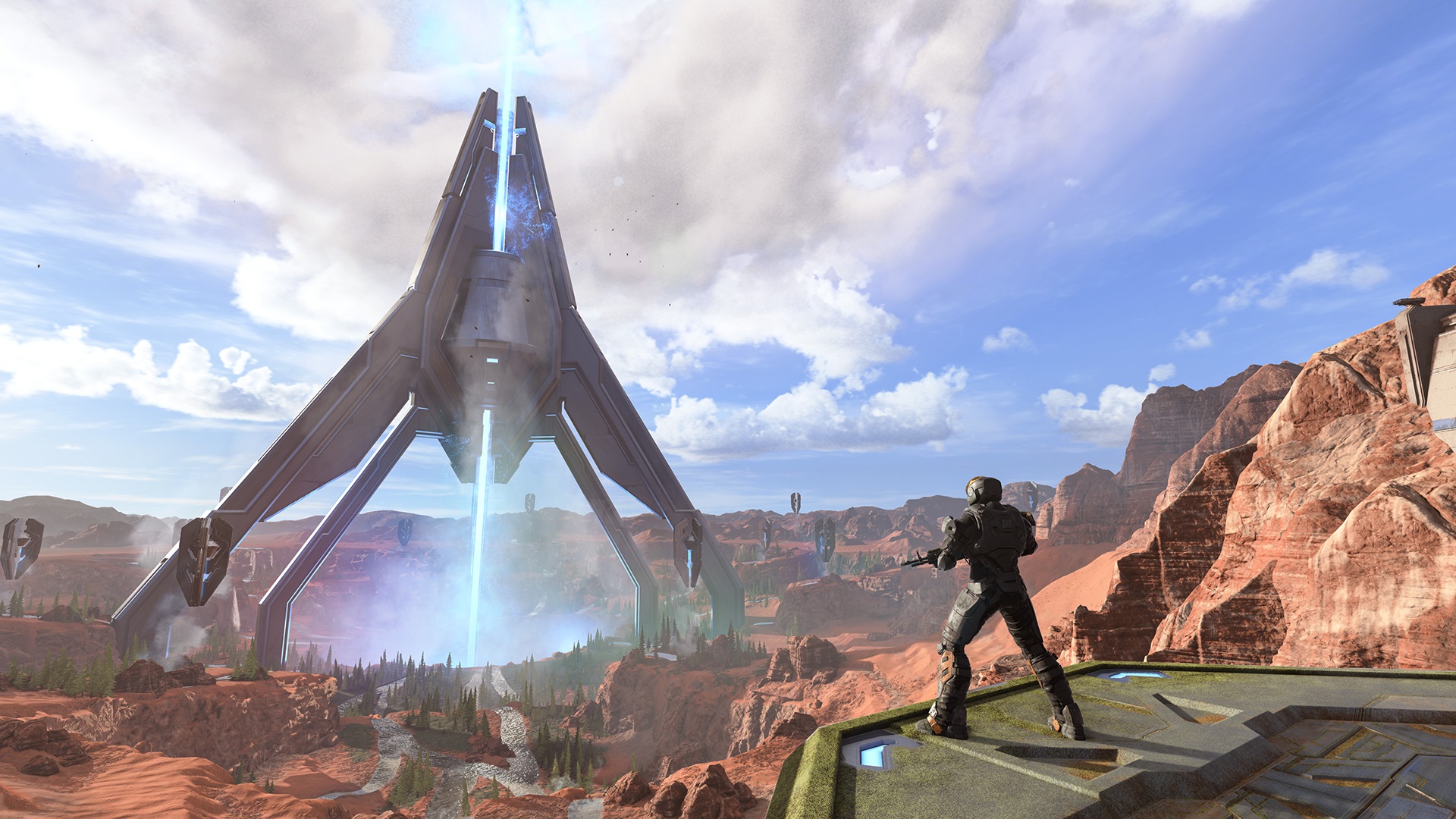 Header image for Halo Infinite Season 3 Maps & Modes blog showing a vista of Oasis with a MIRAGE IIC-clad Spartan looking at the Forerunner ship