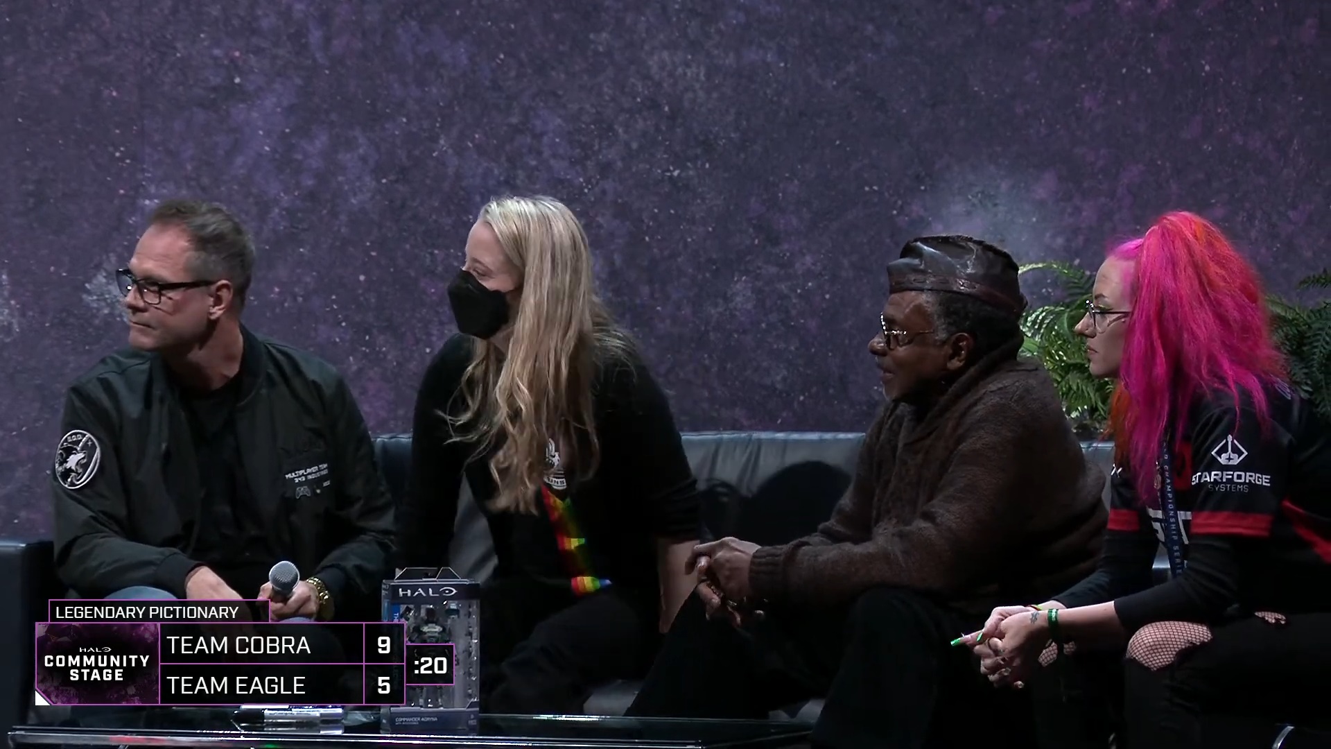 Image of LaSinity at HaloWC 2023 on the Community Stage sat next to Keith David and Jen Taylor