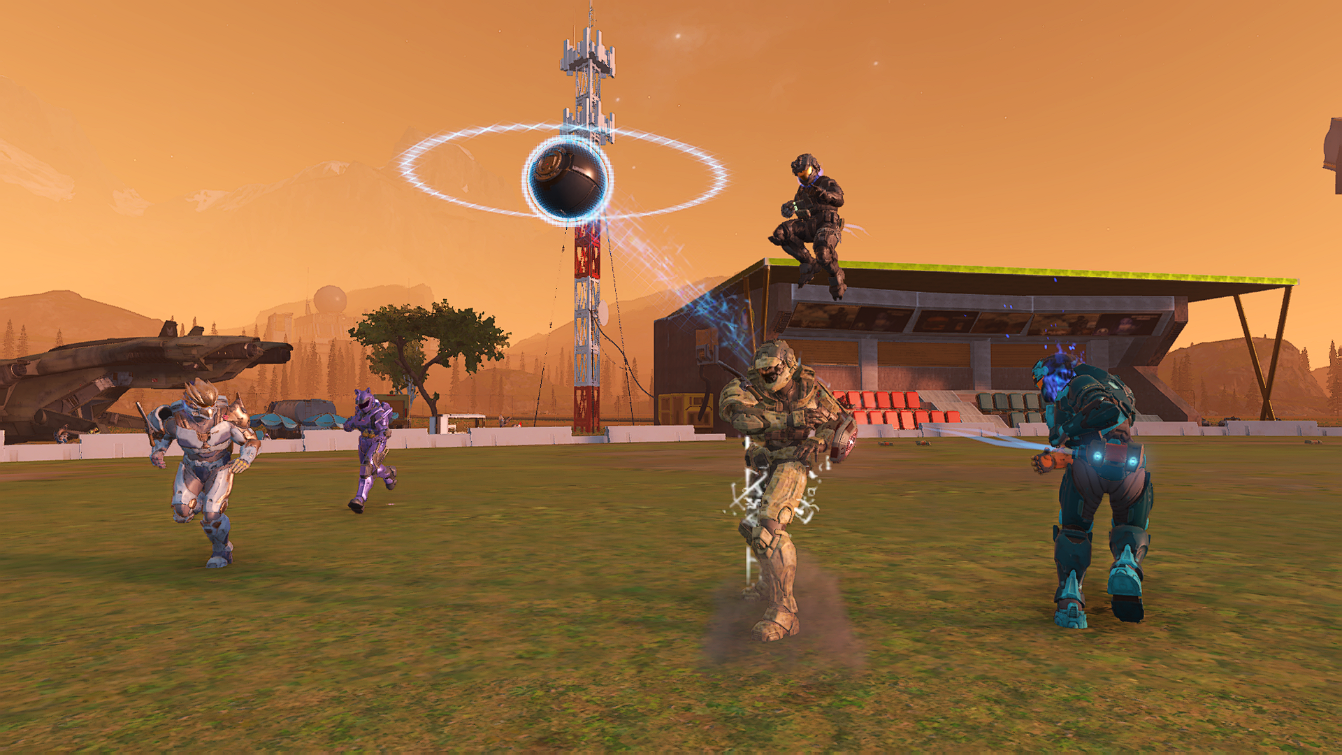 “Cazaly” Forge map. A small-scale version of the Cazalys Stadium in Queensland, Australia. A pavilion encloses two sections of red and blue chairs at the edge of a grassy oval stadium. In the foreground, Spartans pursue a runner as he lobs the ball through the air.