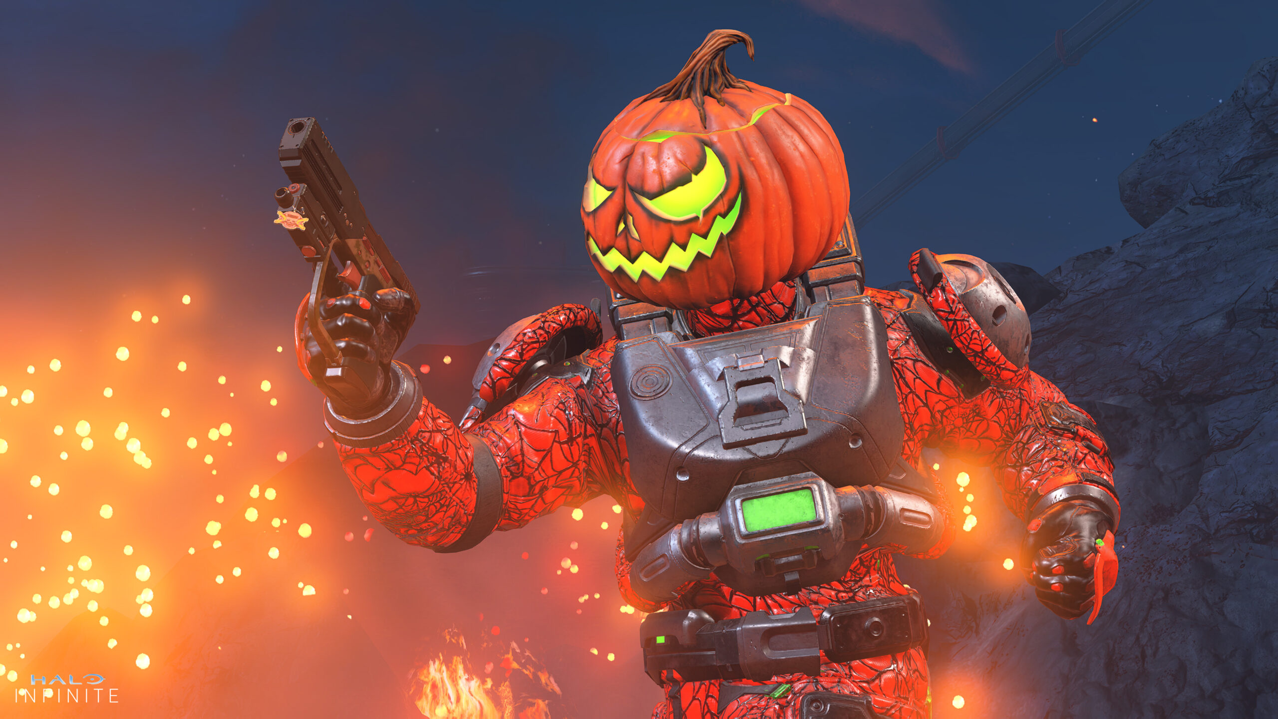 A Spartan in Gourdian Knight armor brandishes a pistol. The Gourdian Knight helmet resembles a Jack O' Lantern with glowing, green eyes and a carven lid. The Weaver's Embrace coating is orange and covered in spooky cobwebs.