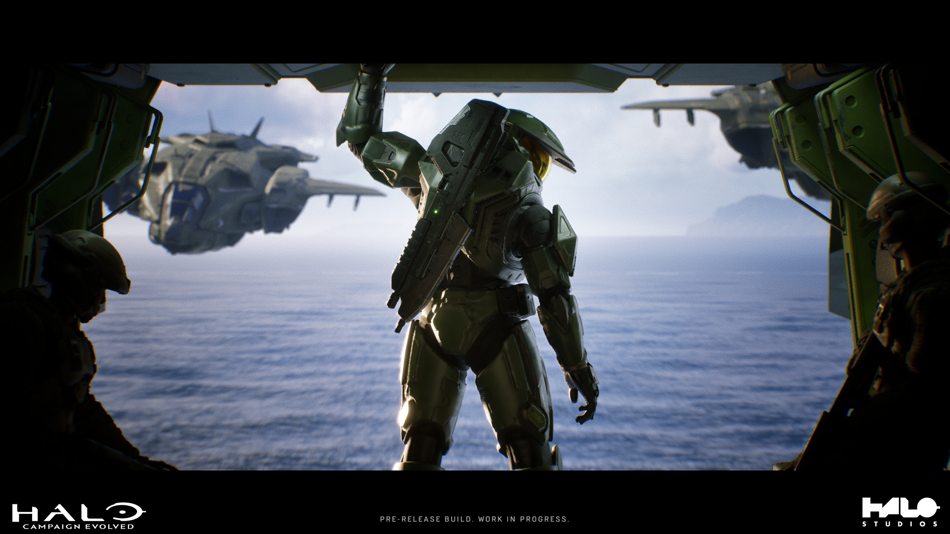The Master Chief stands in the rear hatch of a Pelican as it and two other Pelicans soar over an ocean.