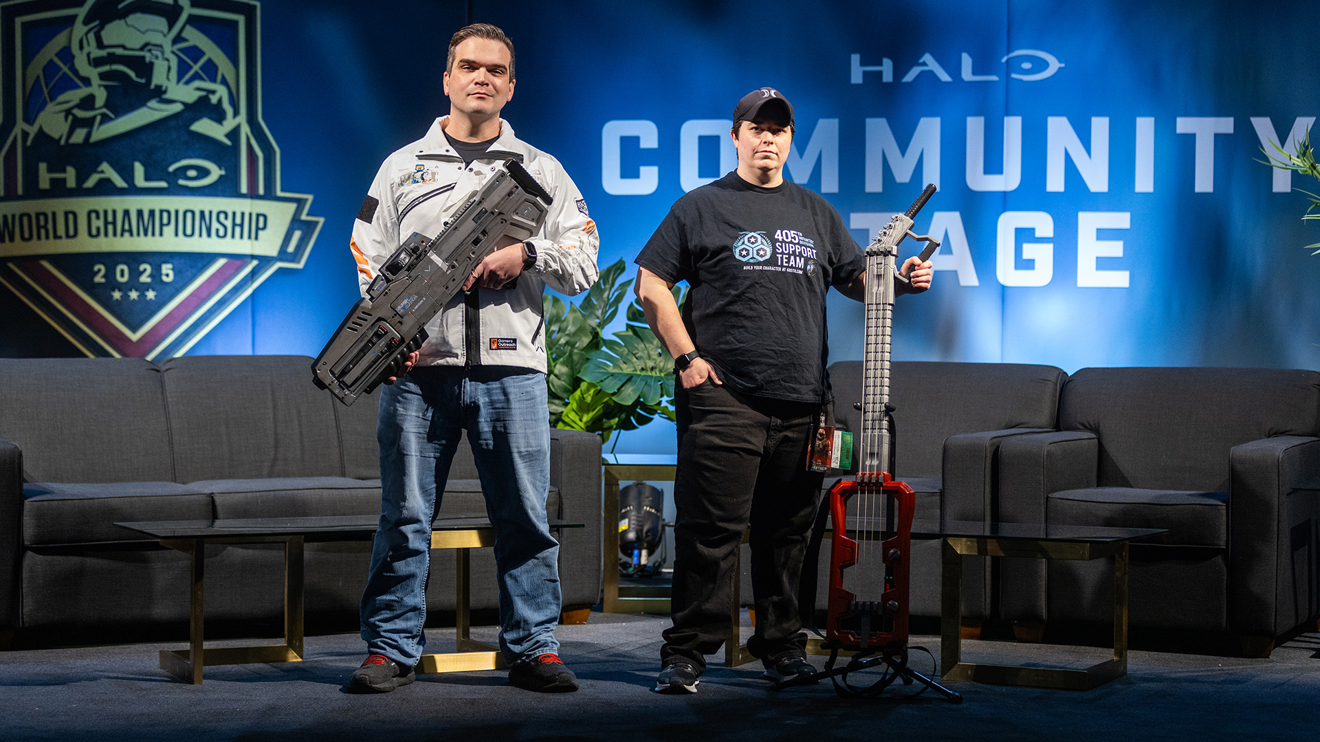 MightyMarkProps holds a replica Hydra beside Fallen922, who stands proudly with her Craig-inspired bass guitar.