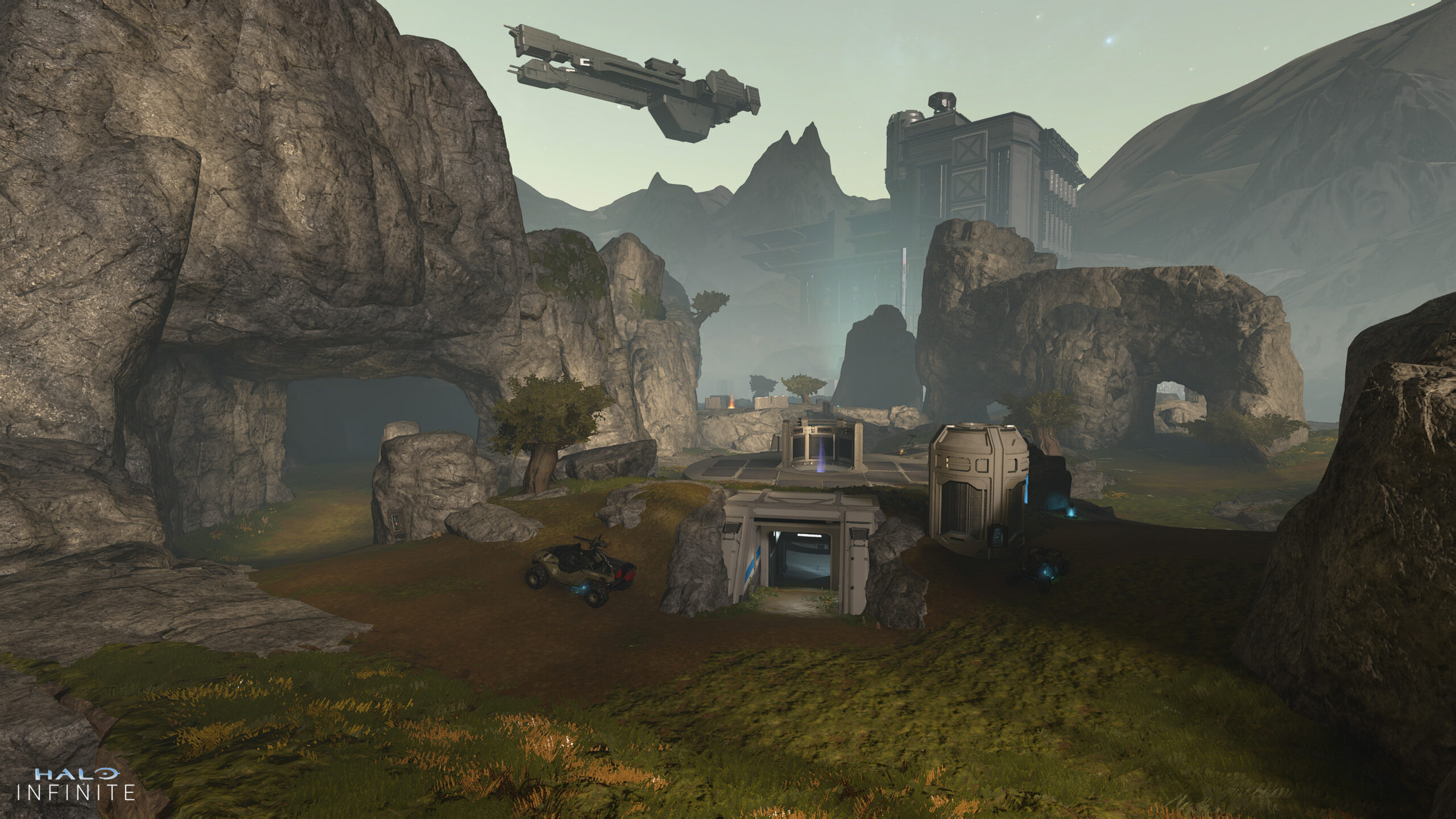 First Light map. A UNSC frigate hovers over a rocky canyon in a grasslands. A bunker is bored into the side of a plateau at the center.