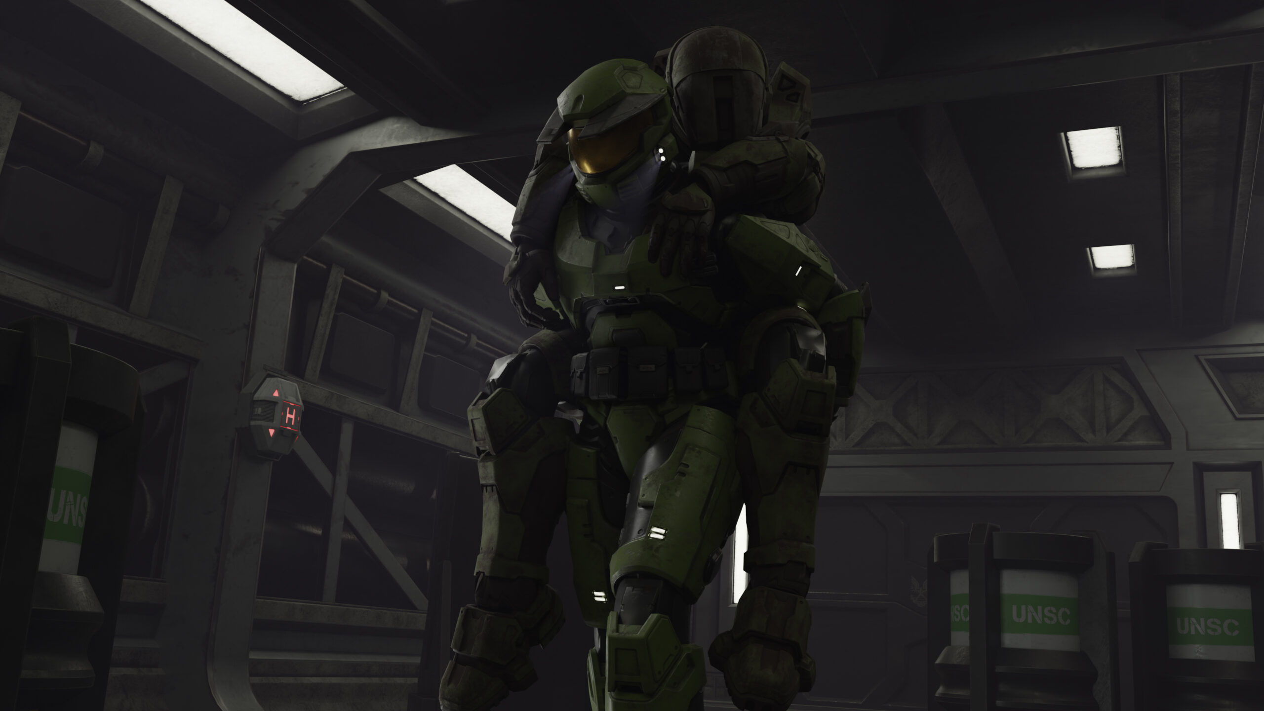 The Master Chief carries a wounded UNSC marine.