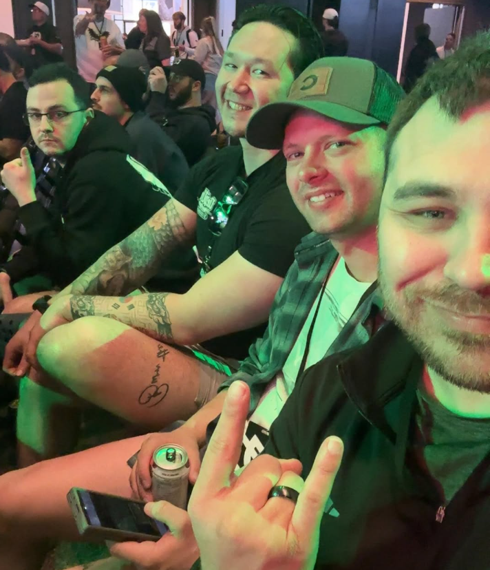 A group of friends cheesing in the audience at an H C S event.