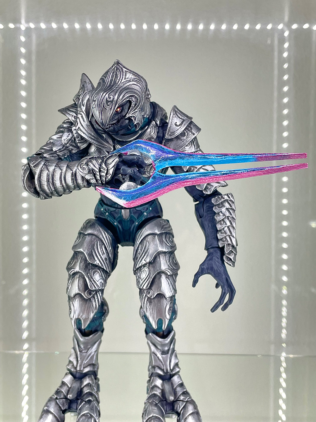 Arbiter with a blue, pink, and purple energy sword.