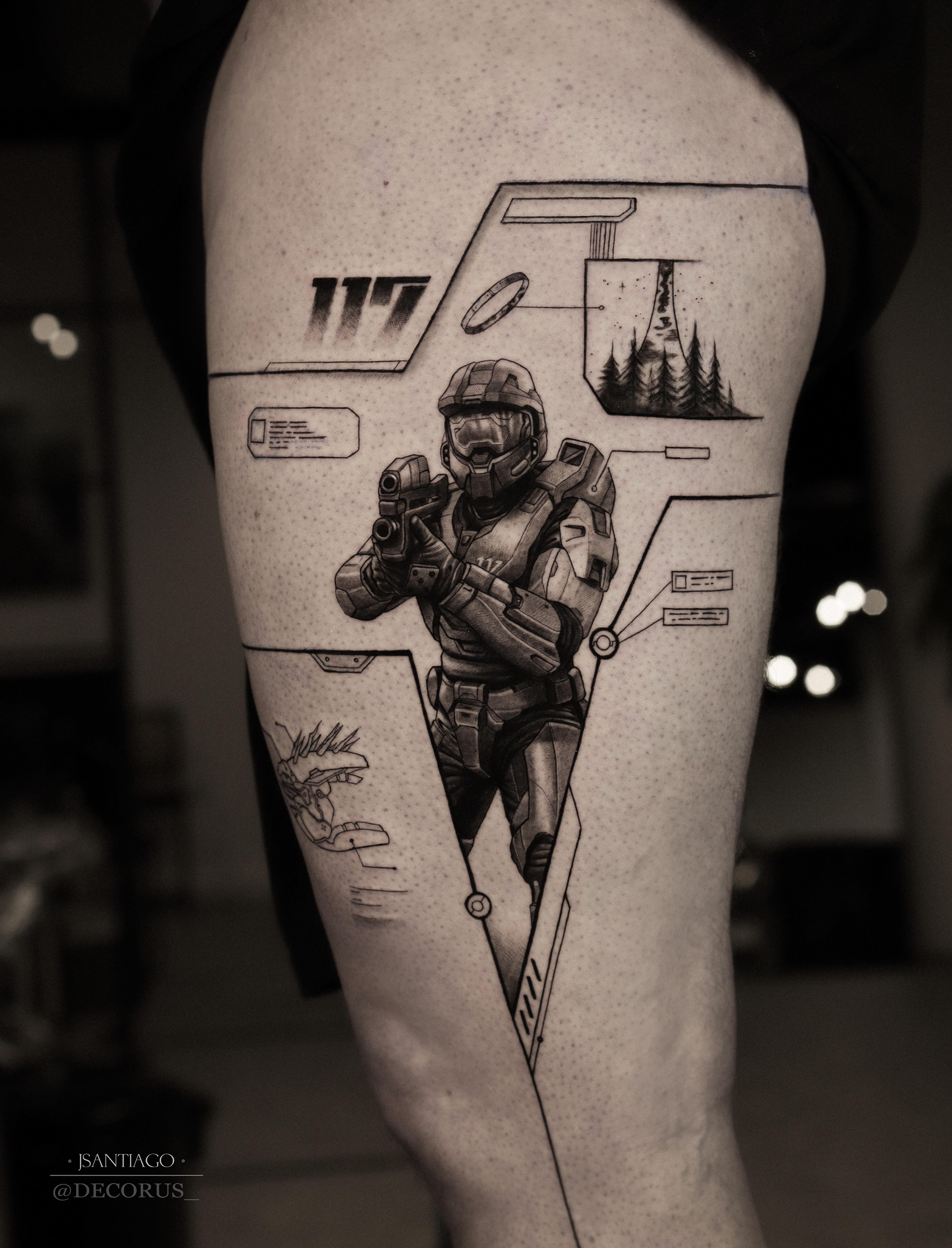 A Master Chief tattoo featuring small details such as the Needler, 117, and a Halo ring around Chief.