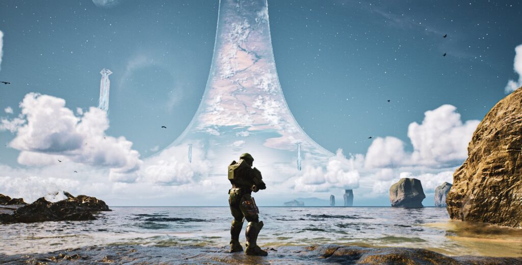 Screenshot by ONNNNNEJAM. The Master Chief wades in the shoals near the Silent Cartographer, framed by the eerie luminescence of the ring.